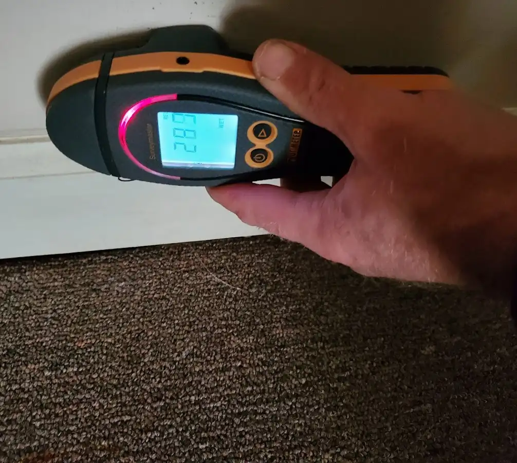 Moisture detection at baseboard during Storm Damage Restoration in Beacon